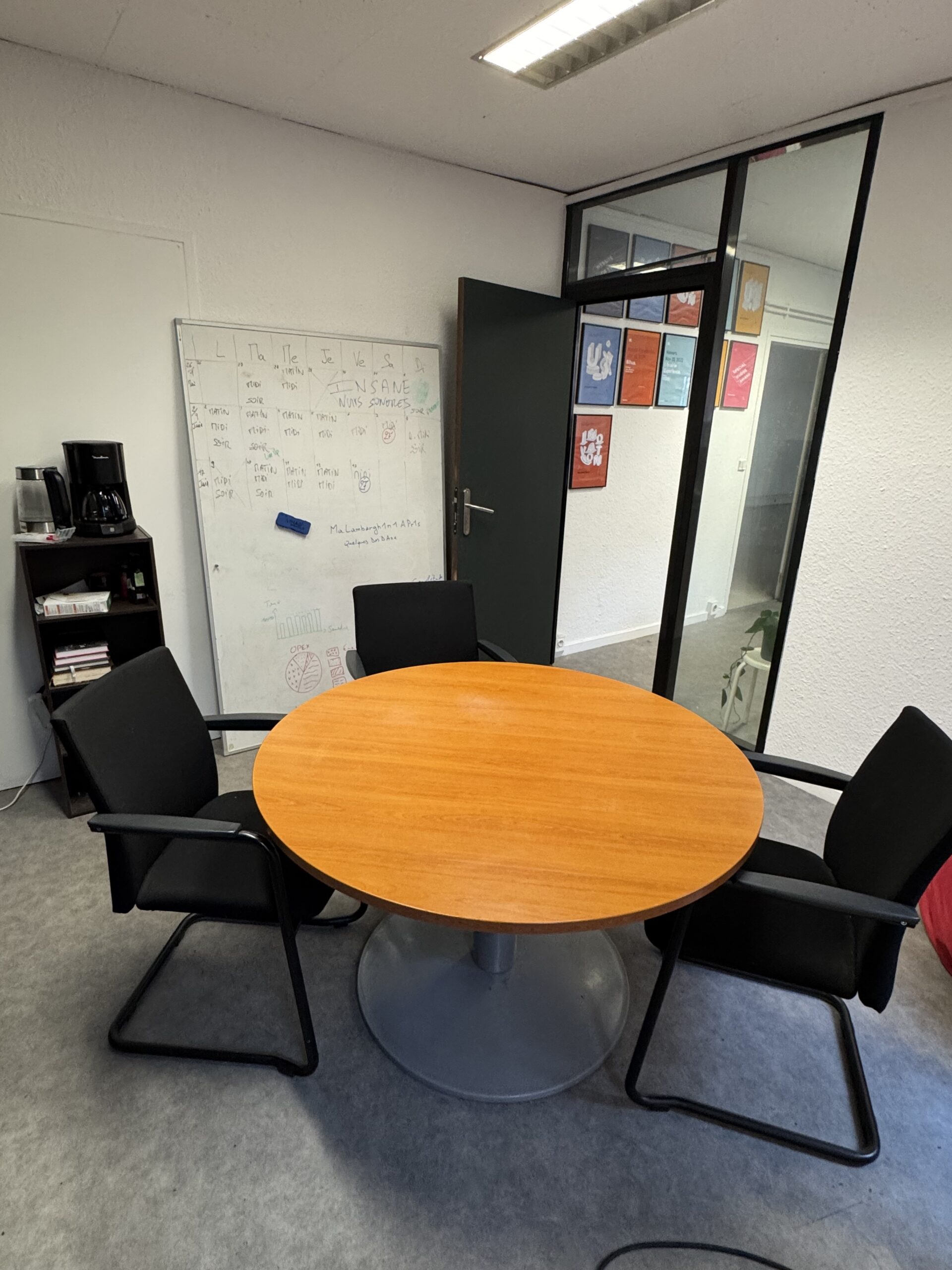 Table ronde et quatre chaises face au tableau blanc dans la salle de cours de Lyon English.